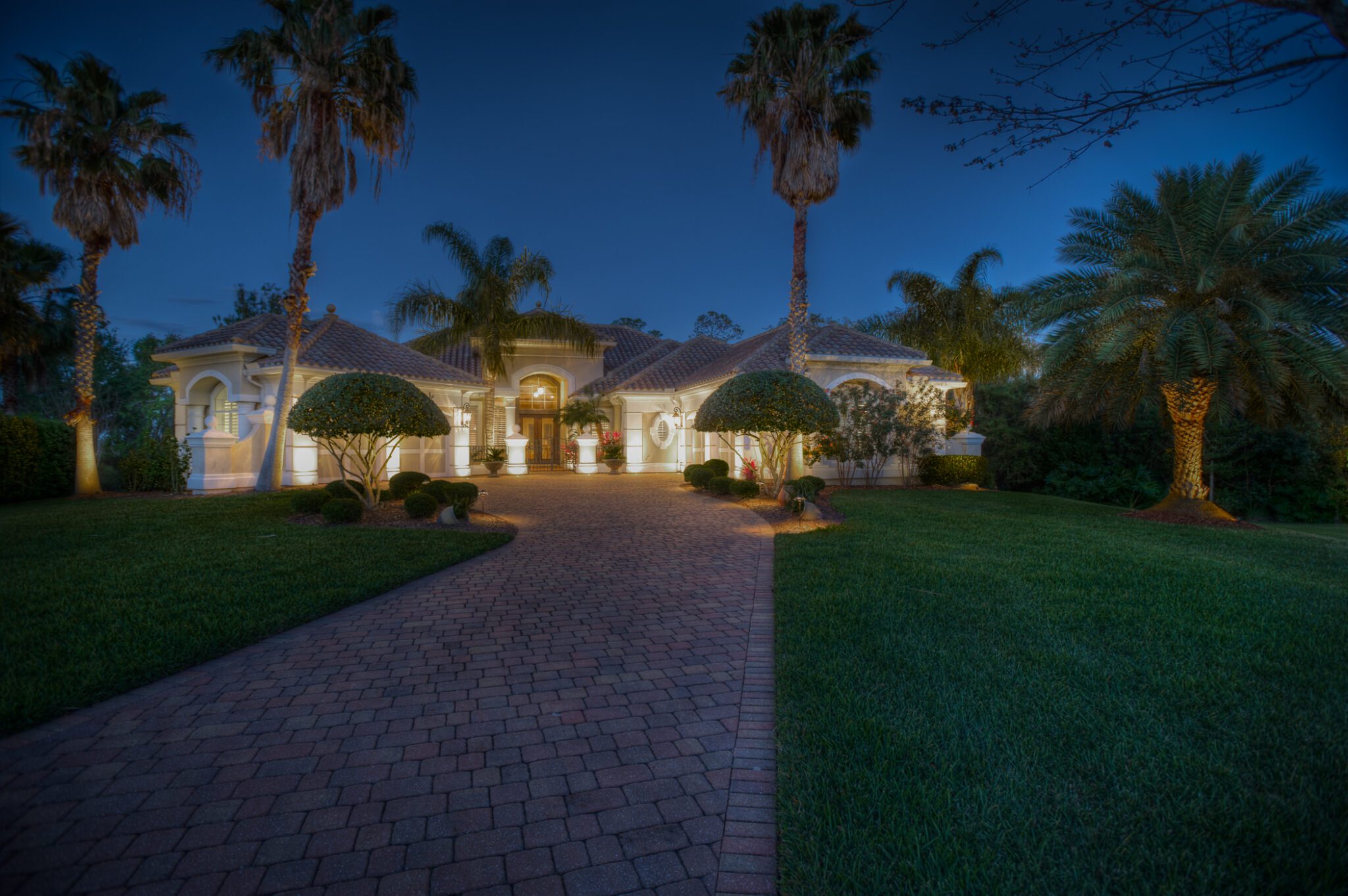 Luxurious home exterior with evening lighting.